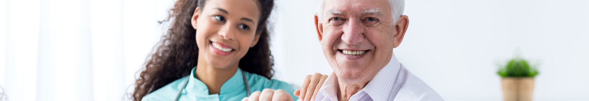 smiling senior man and his caregiver